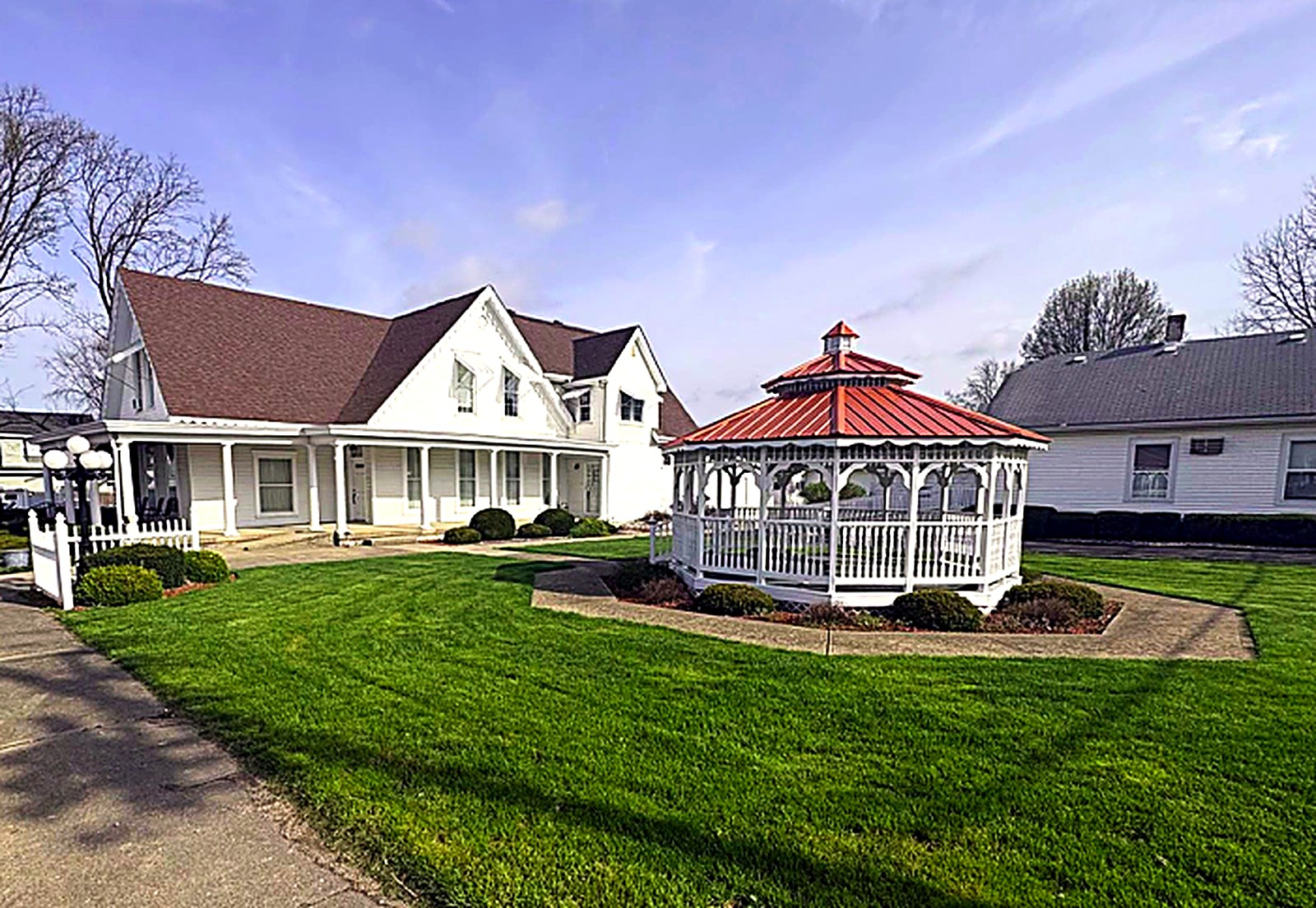 The funeral home grounds with white gazebo and manicured lawn
